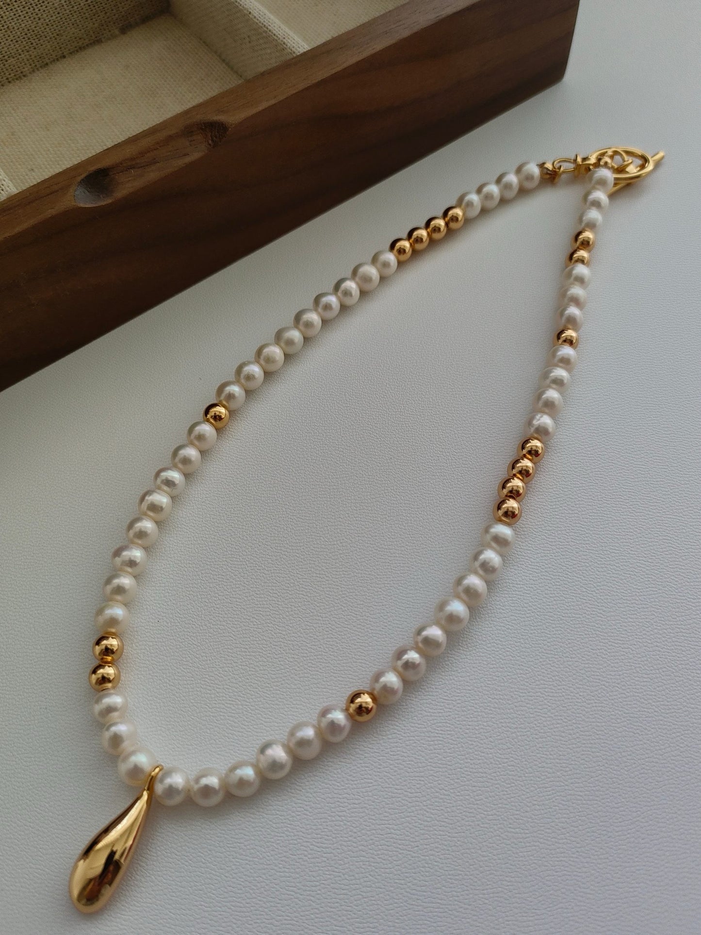 Elegant Pearl Necklace with Vintage Gold Teardrop Pendant